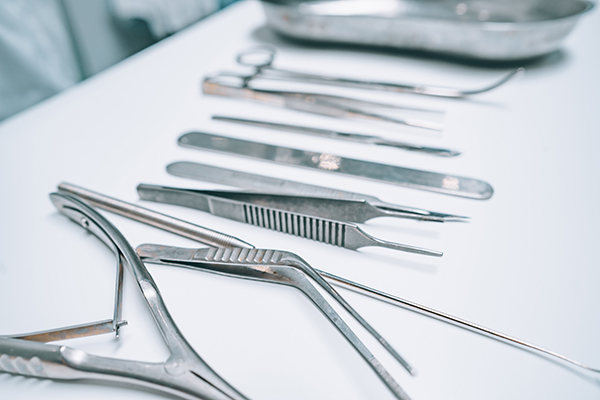 surgical instruments lie on a white table